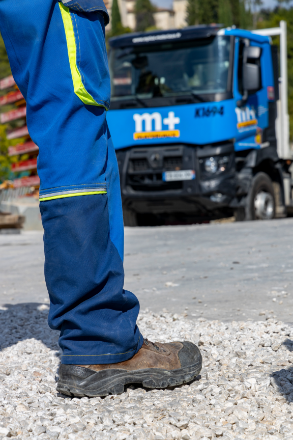 employé M+ debout face à son camion